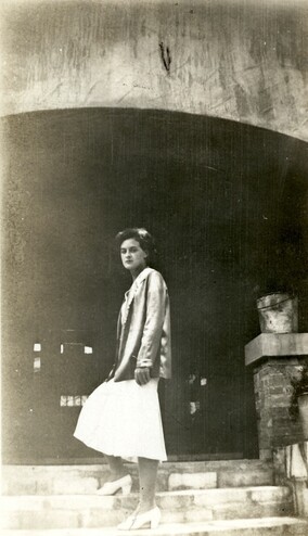 <em>Unidentified woman on the stairs at the south entrance to the Byrne-Reed House. Courtesy of the Reed family.</em>