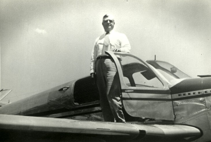 <em>David Reed poses by his plane. Courtesy of the Reed family.</em>